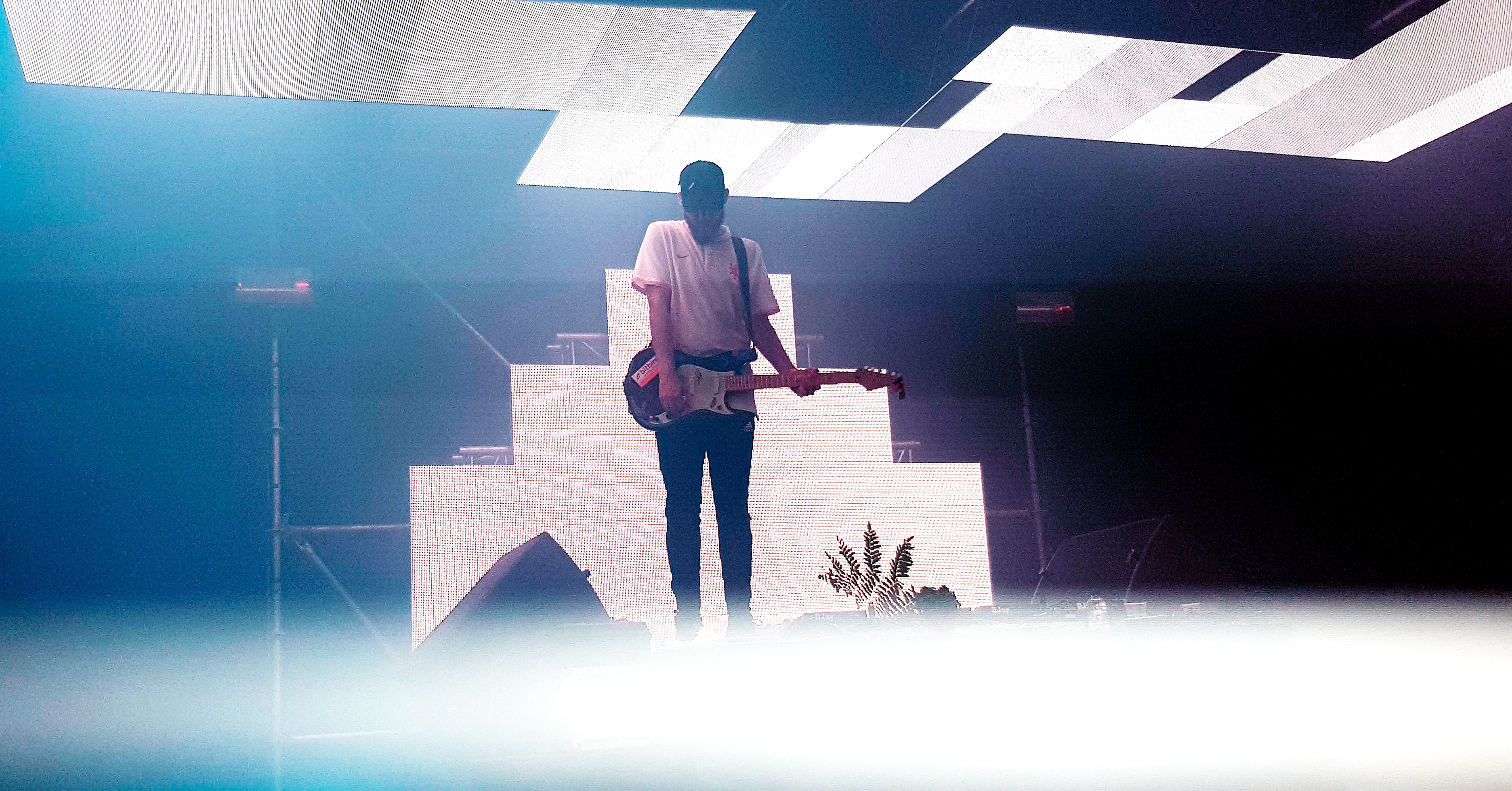 guitarist on a lit up stage